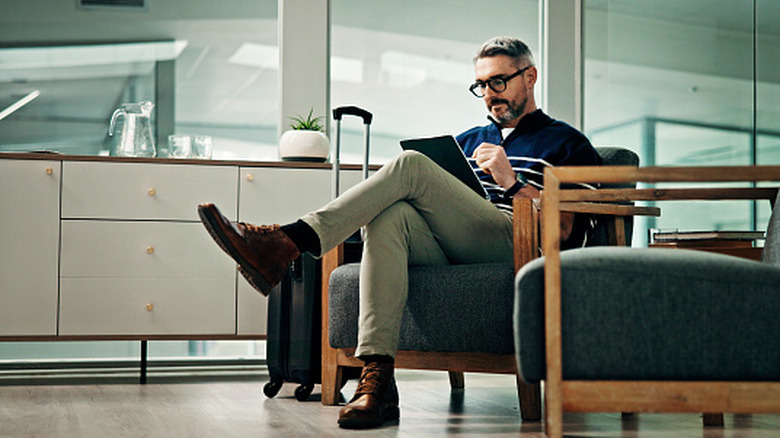 A man sits in an airport lounge