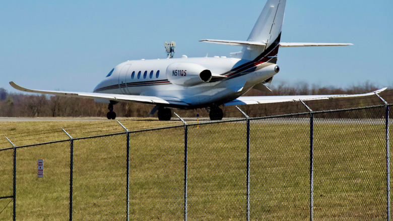 A plane prepares to take off on a sunny day from a small regional airport