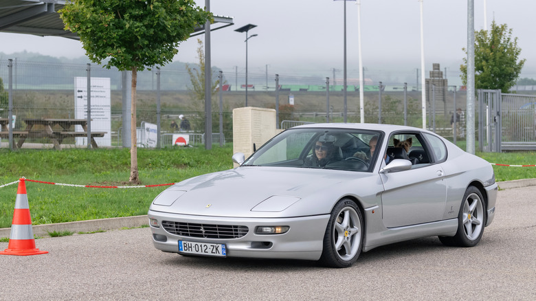 Nancy, France - September 28th 2025 : View on a grey Ferrari 456 GT driving on a street.