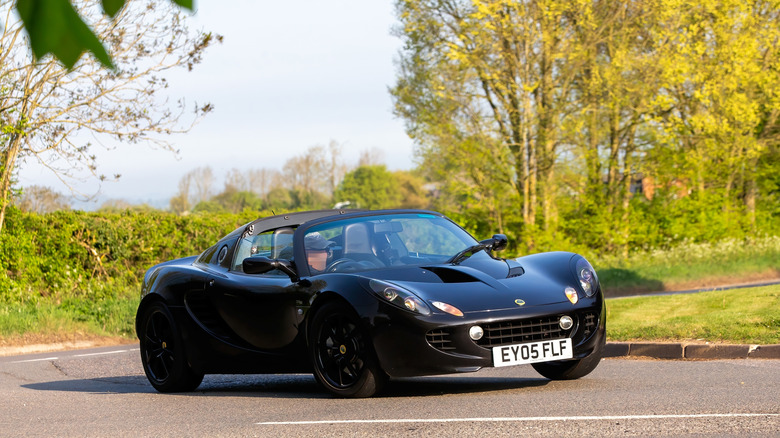 Whittlebury,Northants.,.UK - April 27th 2025: 2005 black Lotus Elise car driving on an English country road.