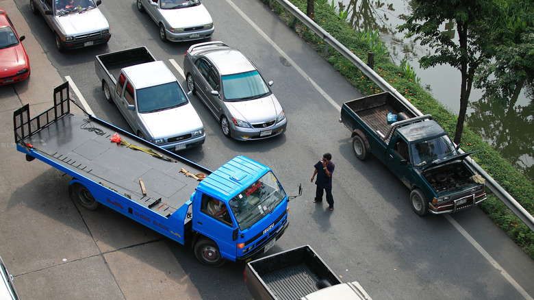 a big blue truck angling its way into traffic