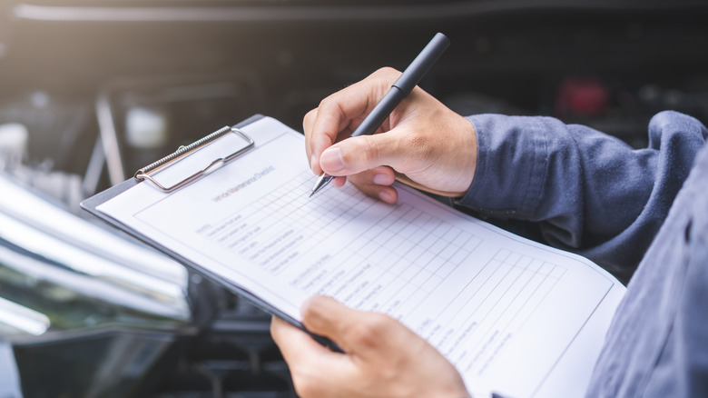 a white man checking off boxes on a list
