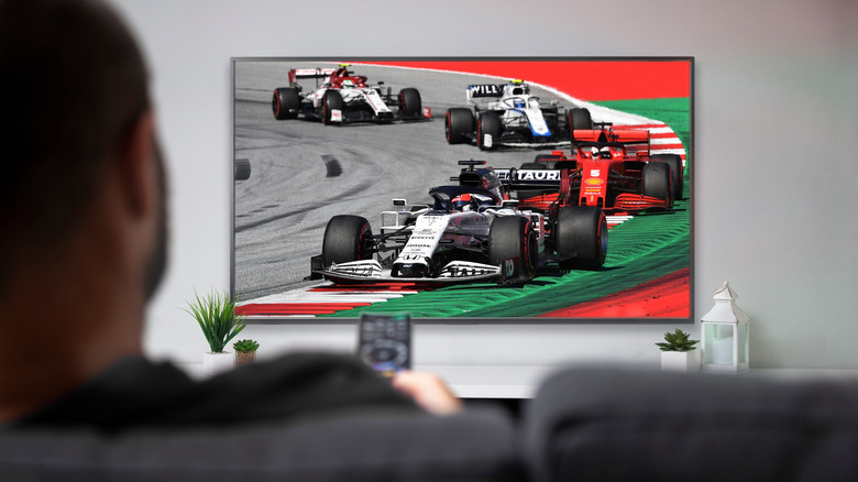 Guy watching F1 on TV