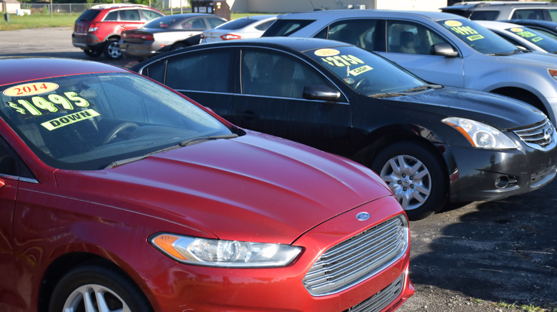 Dayton, Ohio USA June 27, 2024 A row of automobiles on display and for sale at a roadside small business used car lot.