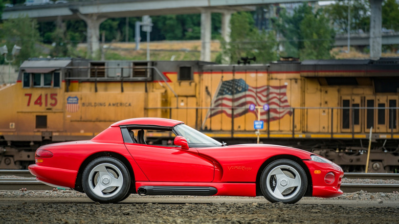 Portland, OR, USA September 12, 2023 Dodge Viper in red showing the passenger side of the car with a train in the background