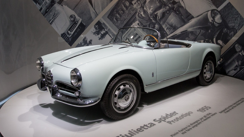 A white Alfa Romeo Giulietta Spider in a museum