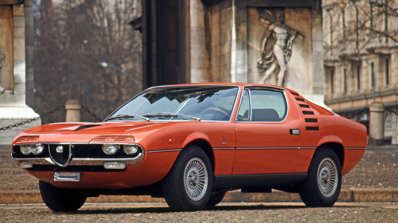 Front 3/4 view of an orange Alfa Romeo Montreal