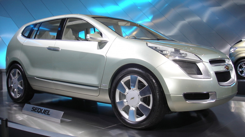 A silver GM concept vehicle parked at an auto show