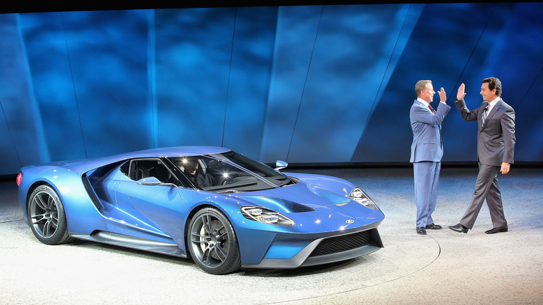 A blue Ford GT parked on a stage at the detroit auto show in 2015