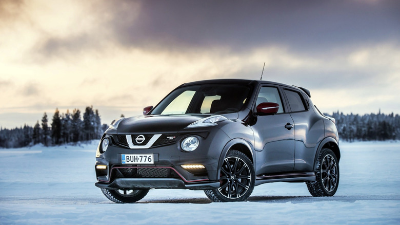 A Nissan Juke Nismo RS parked in the snow under a cloudy sky