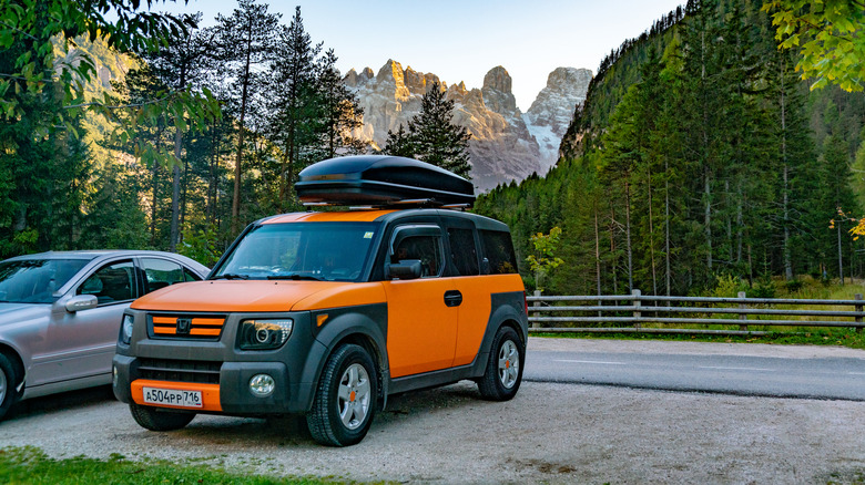 Bright orange Honda Element in the Alps mountains. road trip. Alps. Austria - 29 October 2019