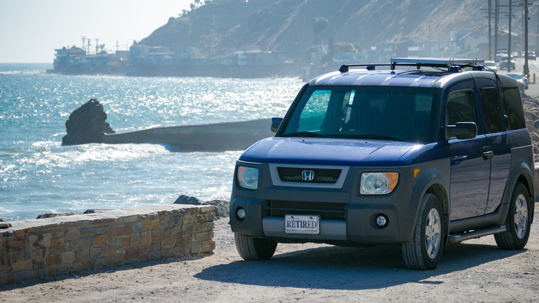 Pacific Coast Highway, California - June 26, 2018: A Honda Element SUV with "RETIRED" license plates stops along the highway to enjoy a view of the Pacific Ocean and beach.