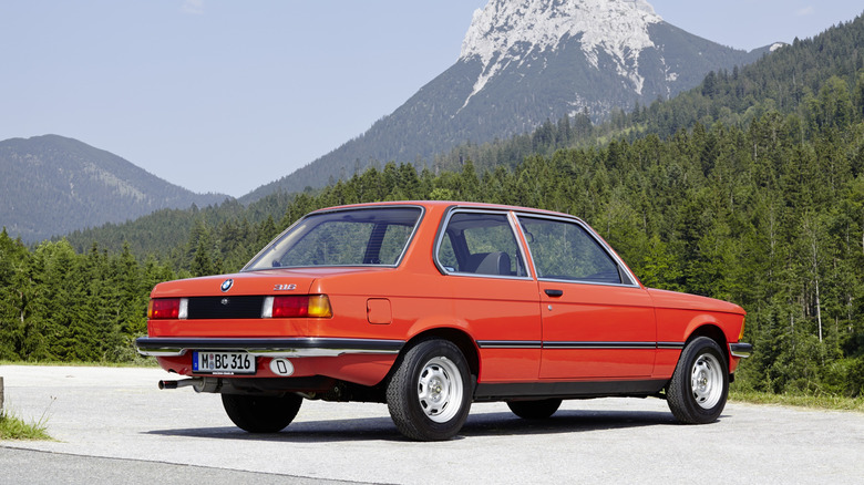 Rear 3/4 view of an orange BMW 3 Series