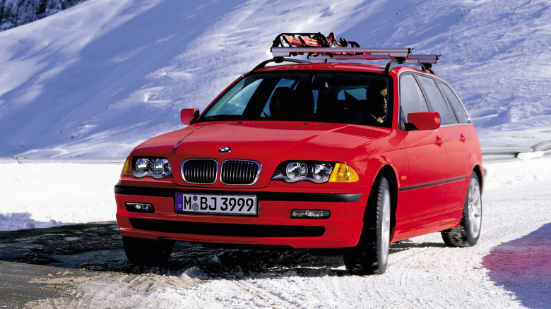 Front 3/4 view of a red BMW 3 Series Touring