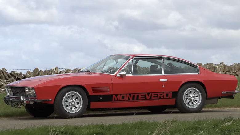 A red Monteverdi High Speed parked under a cloudy day