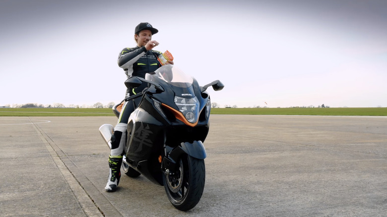 a guy sitting on a Suzuki Hayabusa under a cloudless sky
