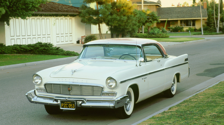 A white Chrysler New Yorker parked on a sunny street