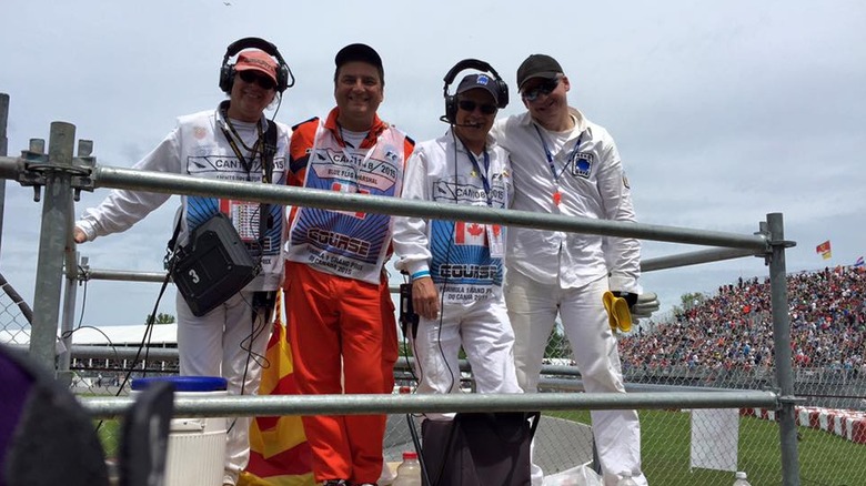 A group of marshals posing for a photo on a platform at the 2015 Canadian Grand Prix