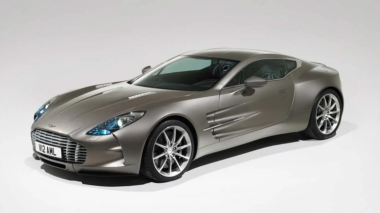 A front three quarters shot of a silver Aston One-77 parked in an all-white studio