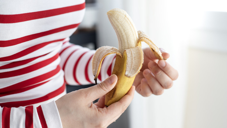 Woman hands peeling a banana