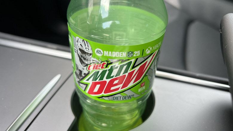 Close-up of a Diet Mountain Dew bottle featuring Madden 25 NFL branding in a car's cup holder, Lafayette, California, March 2, 2025.