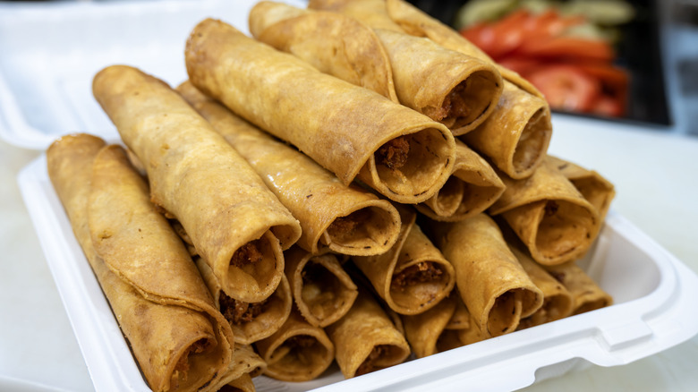 A stack of freshy fried chicken flautas for a special