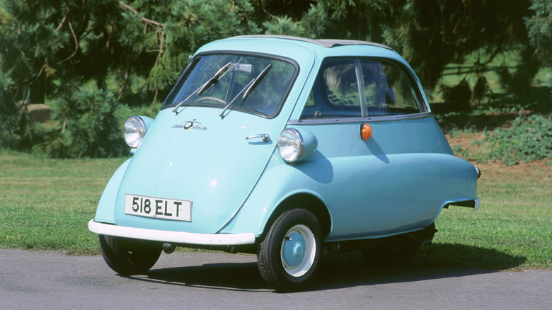 A bmw Isetta parked on grass