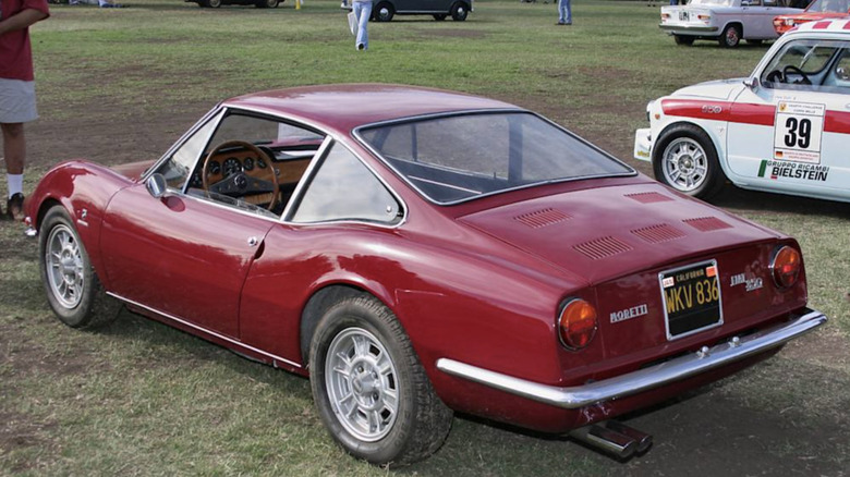 A red Moretti 850 parked on grass