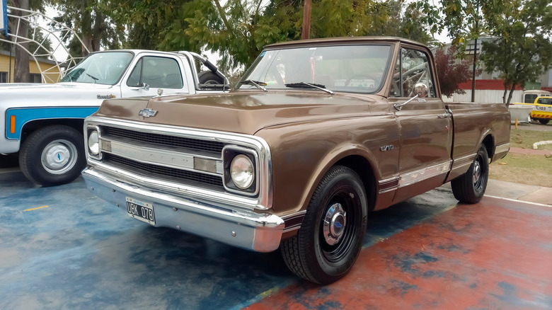 A brown 1970 Chevy C-10 parked in a parking lot