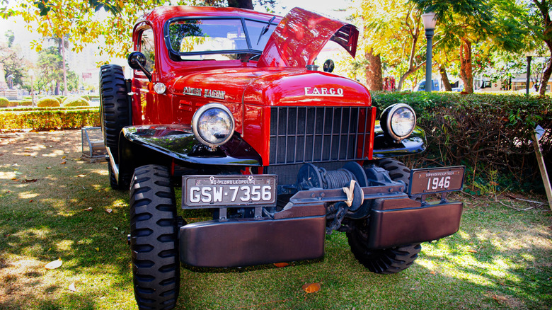 a 1946 Dodge Power Wagon parked in the grass at an auto show