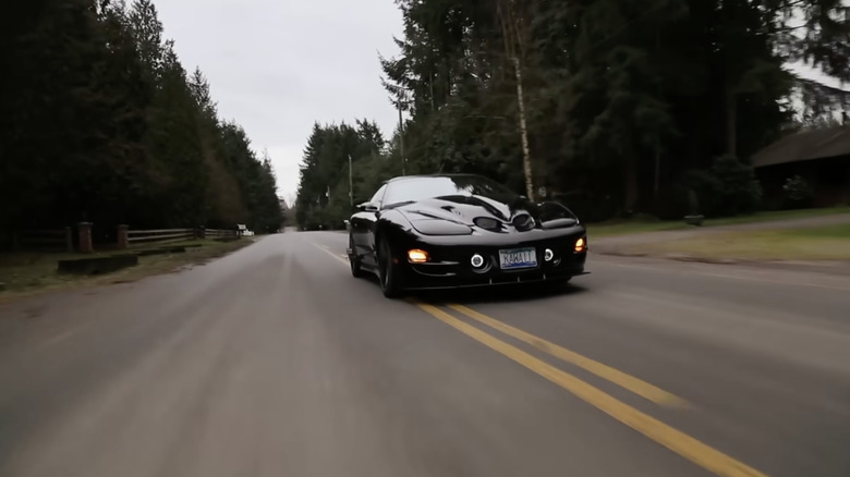 A black pontiac  WS6  speeding down the road