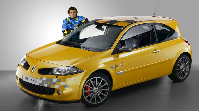 Fernando Alonso posing next to a Renaultsport Megane