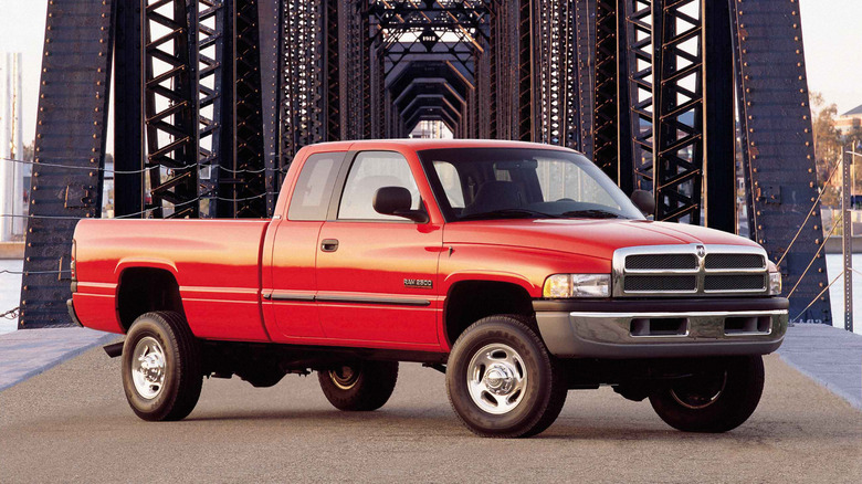 Front 3/4 view of a red Dodge Ram on a bridge