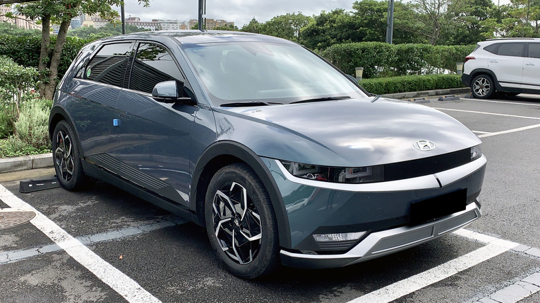 A Hyundai Ioniq 5 parked in a damp parking lot