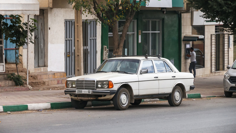 Khenifra Province, Morocco - September 27, 2019: White motor car Mercedes-Benz E-class (W123) in the town street.