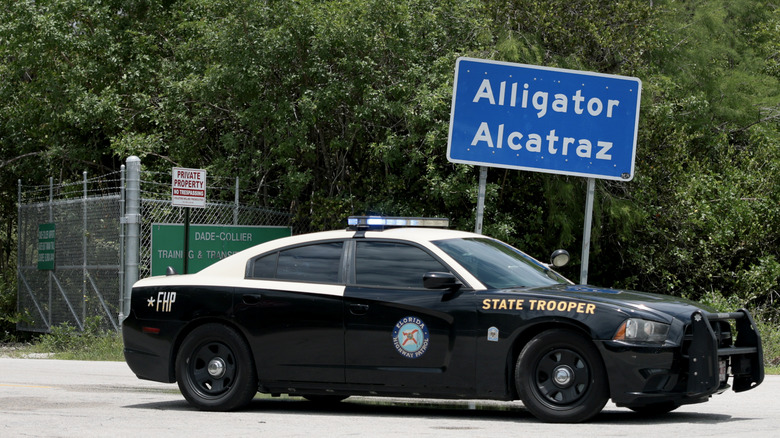 OCHOPEE, FLORIDA - JUNE 01: A Florida High Patrol Trooper pulls out from the front entrance of the immigration detention center in the Florida Everglades, known as "Alligator Alcatraz," on June 01, 2026 in Ochopee, Florida. Reports indicate that the facility will be closed, possibly as early as this month. Florida Gov. Ron DeSantis has not officially confirmed that the closure is taking place. (Photo by Joe Raedle/Getty Images)