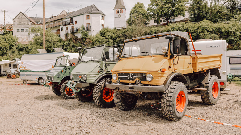 Schuld, Germany - 23rd May 2026, Three different Unimogs against the backdrop of Schuld