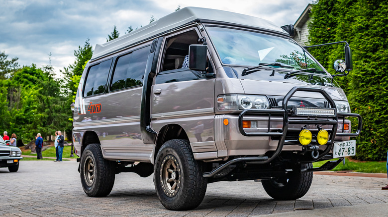  Low position beforehand area position of a 1993 Mitsubishi Delica Potenza Pop-Top Camper Van leaving a section car show.