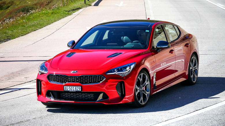 Saint Gotthard Pass, Switzerland - September 13, 2019: Red saloon car Kia Stinger at the interurban road.