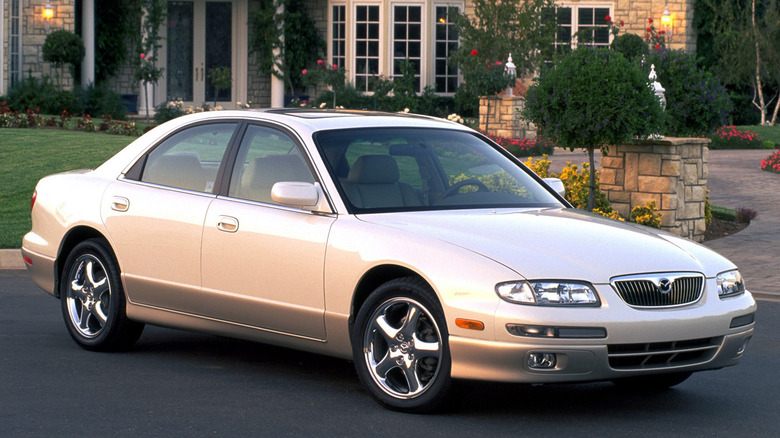 Front 3/4 view of a white and gold Mazda Millenia
