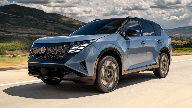 Front 3/4 view of a blue 2027 Nissan Rogue Hybrid