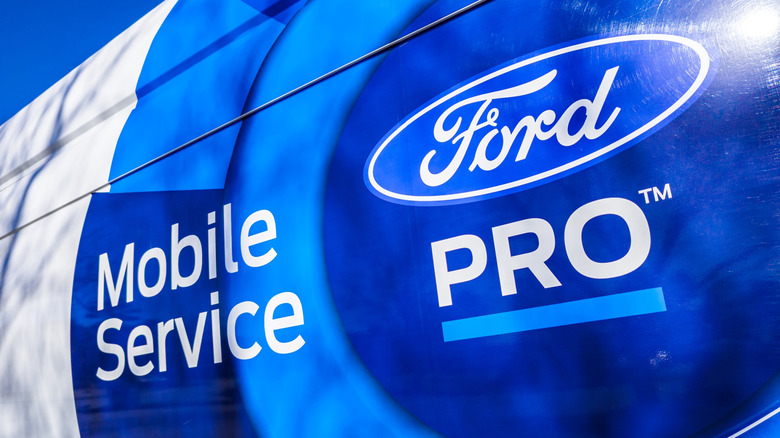 The side panel of a Ford mobile service van with logos and graphics