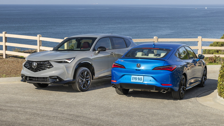 A grey Acura ADX next to a blue Acura Integra