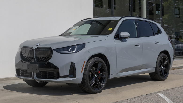 A gray BMW X3 in front a building.