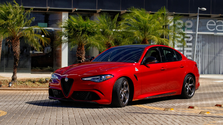 Minas Gerais, Abril - 20 10 2025: Red Alfa Romeo Giulia Quadrifoglio parked, high-performance italian sports sedan