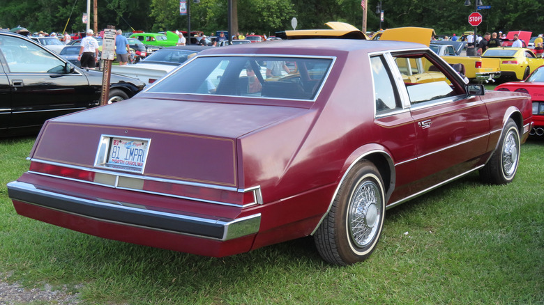 Red 1981 Imperial coupe seen from right rear parked at outdoor car show