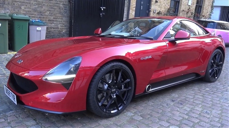 Red TVR Griffith seen from front left parked in a cobblestone courtyard