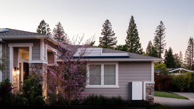 Tesla Powerwall by a house