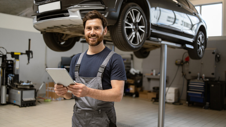 Smiling mechanic in shop.