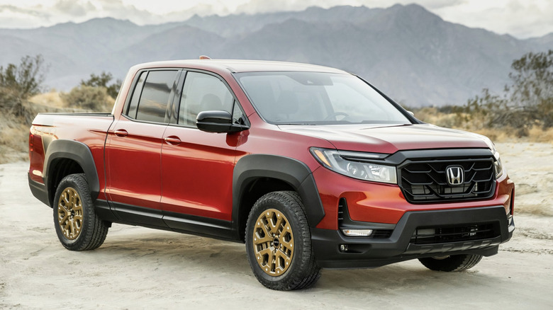 A red Honda Ridgeline parked in the desert
